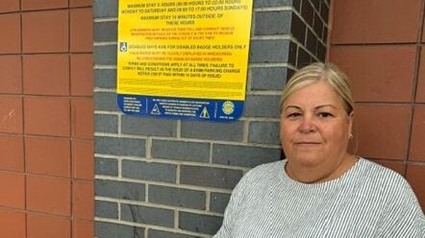 Kathryn with a car park sign